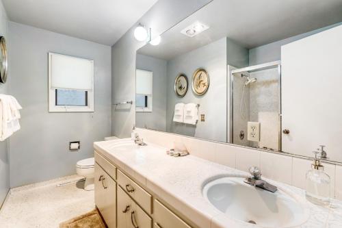 a bathroom with a sink and a toilet and a mirror at Livin' the Dream in Pebble Beach