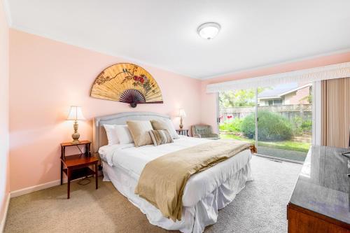 a bedroom with a bed and a large window at Livin' the Dream in Pebble Beach