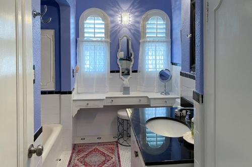 a bathroom with a sink and a mirror at Woodlawn Avenue Beauty in San Antonio