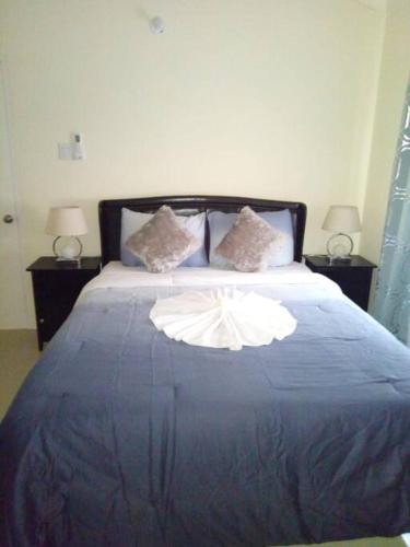 a bedroom with a large bed with a blue blanket at Ocean View Get Away in Falmouth