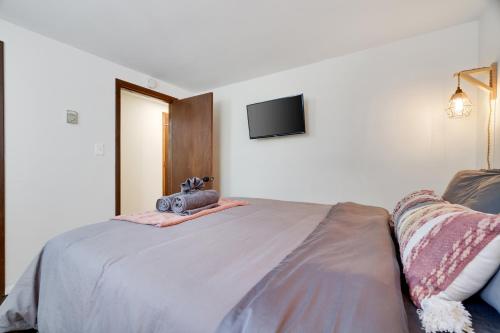 a bedroom with a bed with a camera on it at Camp Cedar:7 miles to Camelback, 5 to Kalahari! in Long Pond