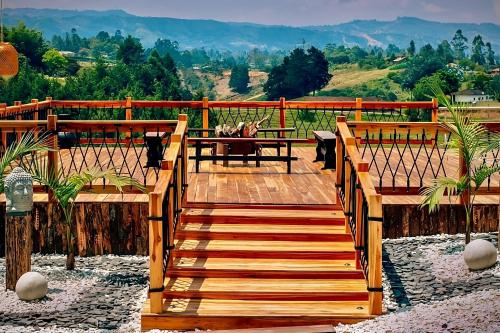 a wooden walkway with a view of a mountain at Örök Hotel in Rionegro