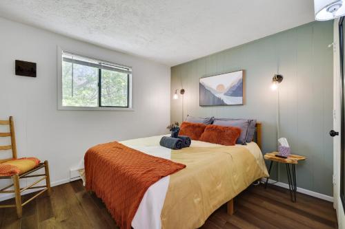 a bedroom with a large bed with orange pillows at Camp Cedar:7 miles to Camelback, 5 to Kalahari! in Long Pond