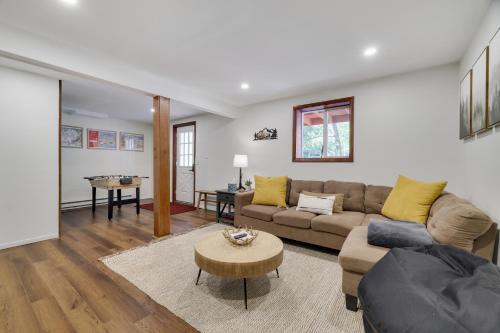 a living room with a couch and a table at Camp Cedar:7 miles to Camelback, 5 to Kalahari! in Long Pond