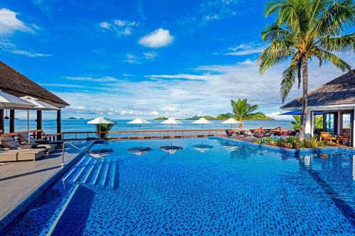 a pool at a resort with the ocean in the background at Sheraton Resort & Spa, Tokoriki Island, Fiji in Tokoriki