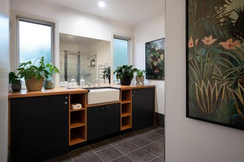 a bathroom with a sink and a mirror at Kuca Stone in Daylesford