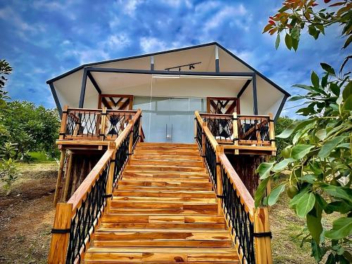 a home with a wooden staircase leading to a house at Örök Hotel in Rionegro