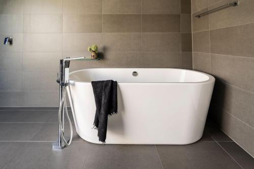 a white bath tub sitting in a bathroom at Stage 1 in Point Lonsdale