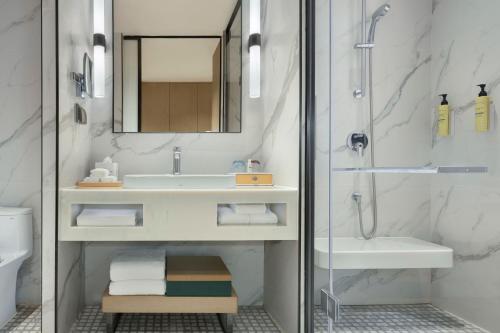 a bathroom with a sink and a shower at Element Guangzhou Baiyun in Guangzhou