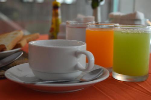 a cup of coffee and two drinks on a table at AYA Boutique Hotel Pattaya - SHA Plus in Pattaya