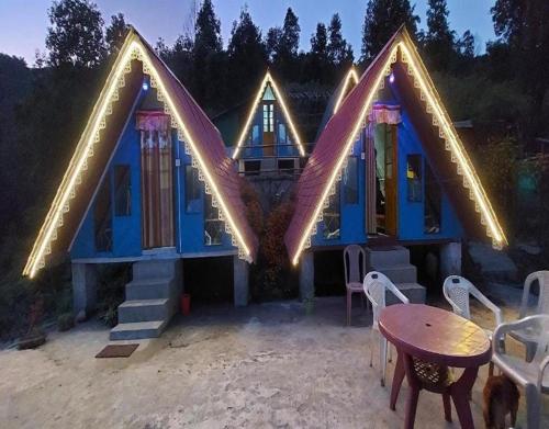 a blue house with lights on the front of it at Newang Gaon Eco Homestay Aaradhya by StayApart in Kalimpong
