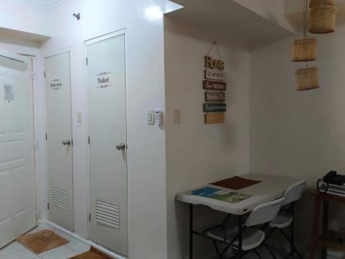 a bathroom with a shower and a table and a desk at B123 Unit 1852 Prime Residences Tagaytay Condominium - Budget Staycation - Not 5-star Hotel Accommodation in Tagaytay