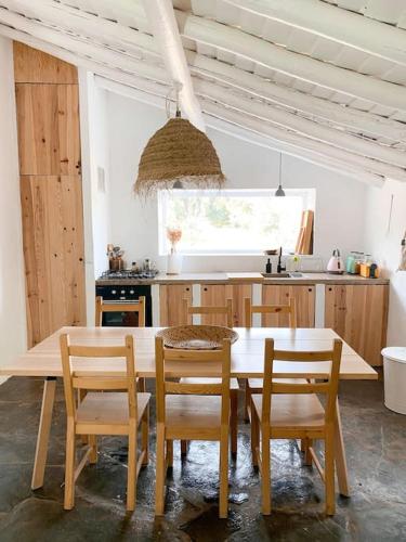 a kitchen with a table and chairs in a kitchen at Monte da Borrega - Casa de Campo in Esperança