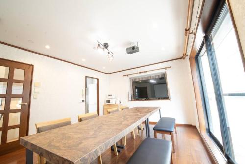 a large room with a large table and chairs at la3 hotel annex 新宿三階建て一軒家 in Tokyo