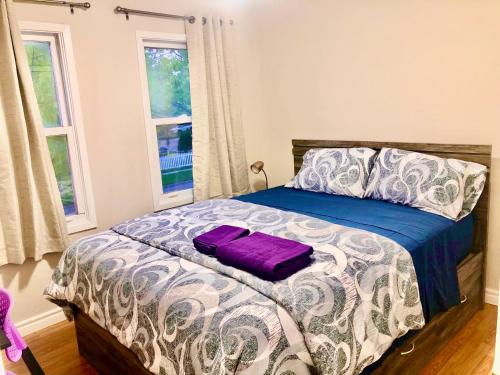 Un dormitorio con una cama con una bolsa morada. en CozyHome en Markham