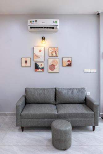 a living room with a couch and a wall with pictures at TRUONG TIEN HOTEL in Hue
