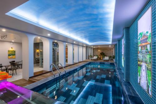 a swimming pool in a building with a ceiling at TRUONG TIEN HOTEL in Hue