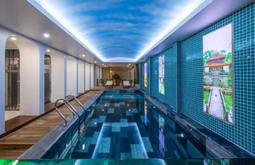 a swimming pool with a blue ceiling at TRUONG TIEN HOTEL in Hue