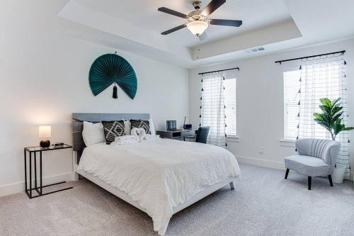 a bedroom with a bed and a ceiling fan at 2022 quiet relaxing and secure town house near Atlanta in Redan