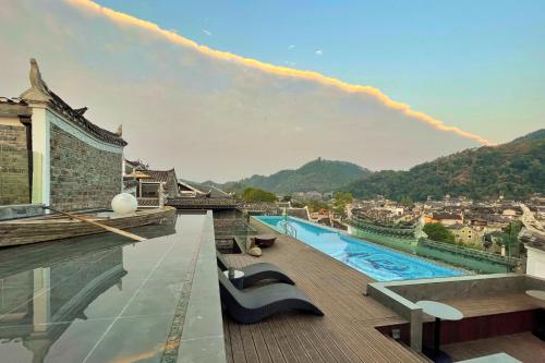 a rooftop swimming pool on top of a building at Phoenix Hall House Hotel in Fenghuang County