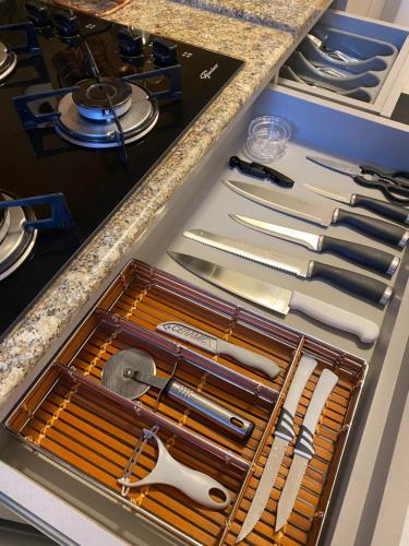 a drawer full of utensils in a kitchen at Apartamento proximo a Rua Coberta GIJOCA 01 in Gramado