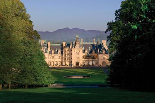 a large castle sitting on top of a lush green field at Holiday Inn Express & Suites Asheville SW - Outlet Ctr Area by IHG in Asheville