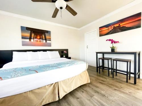 a bedroom with a bed and a table at The Palms in Hollywood