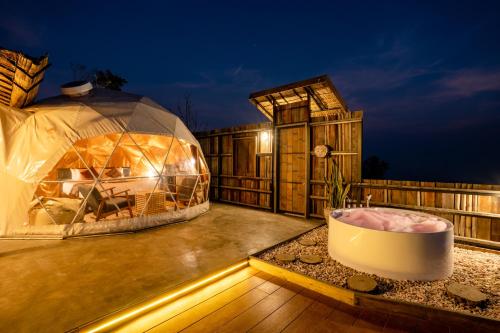 a dome house with a bath tub on a deck at CLIFF VERANDAH @ DOI LAN in Ban Huai Khai