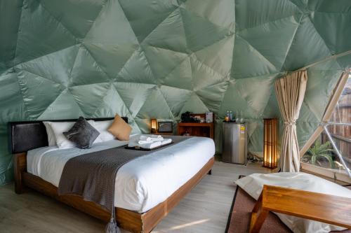 a bedroom with a bed in a tent at CLIFF VERANDAH @ DOI LAN in Ban Huai Khai