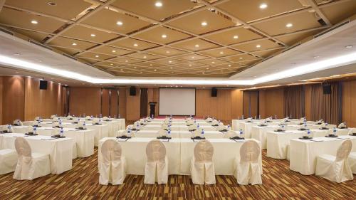 a large banquet hall with white tables and chairs at Marco Polo Parkside, Beijing in Beijing