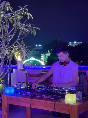 a man standing behind a keyboard at night at Ngon Avatar Hotel in Pleiku