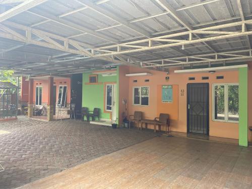 a room with tables and chairs in a building at Bu Sur Homestay in Bogor