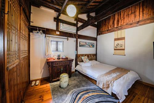 a bedroom with a bed and a desk in it at Hui Boutique hotel in Huangshan