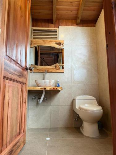 a bathroom with a toilet and a sink at La Casa de Martin in Baños