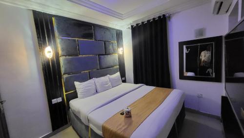 ein Schlafzimmer mit einem großen Bett in einem Zimmer in der Unterkunft Palazzo Apartments in Ikeja