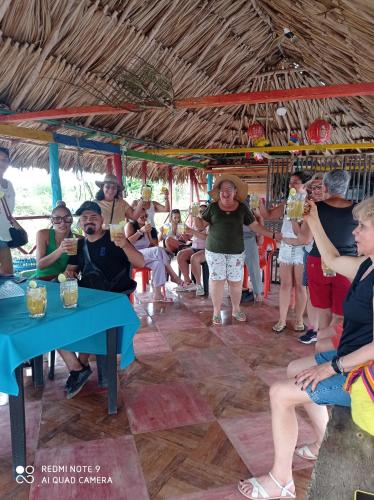 a group of people sitting on a carousel at HOSTAL BELLEZA TROPICAL in Moñitos