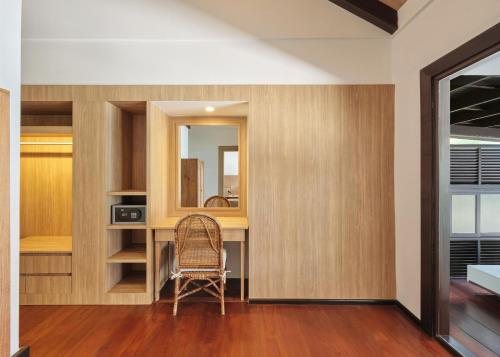 a room with a desk with a chair and a mirror at Garrya Tongsai Bay Samui in Choeng Mon Beach