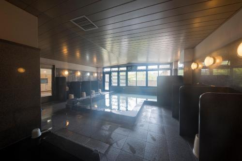 a room with a swimming pool in a building at Ayagawasou in Miyazaki