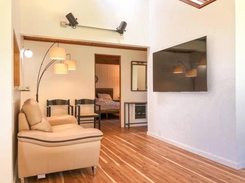 a living room with a couch and a tv at Amazing ocean views, bright and modern in Sea Ranch