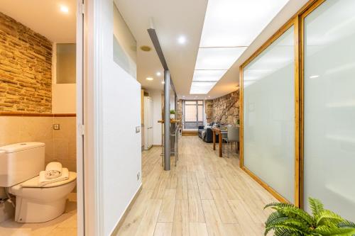 an office corridor with a toilet and a glass door at Lo Petitó de la Part Alta in Tarragona