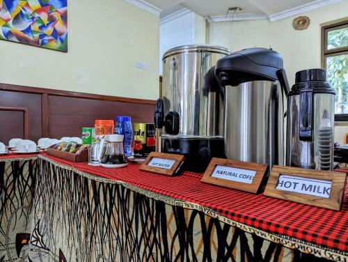 a table with a counter top with a hot milking at Mvuli Hotels Arusha in Arusha