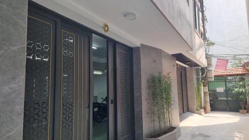 an entrance to a building with glass doors at Era Apartment Khuc Thua Du in Hanoi
