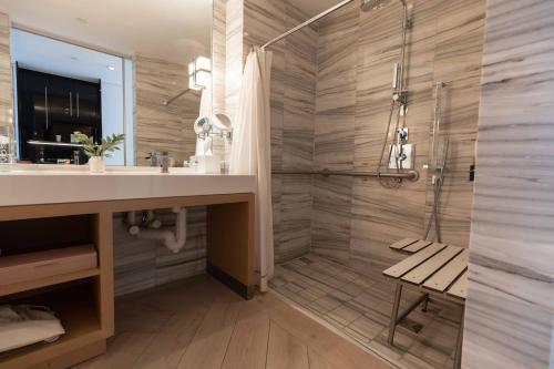 a bathroom with a shower and a sink at W South Beach in Miami Beach