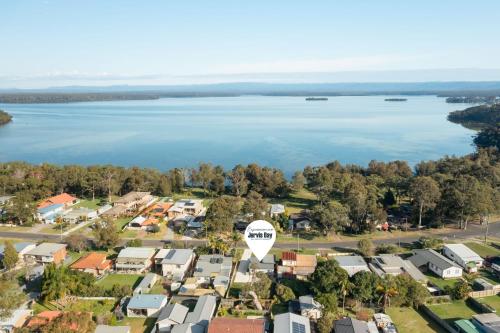 an aerial view of a suburb with a lake at Wanderer by Experience Jervis Bay in Sanctuary Point