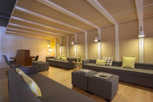 a large living room with couches and tables at Cabot Romantic- Adults Only in Port de Pollensa