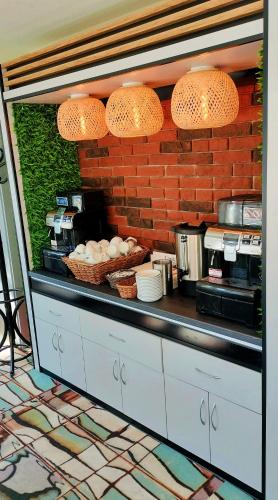 a kitchen with a counter with a brick wall at Great Polonia River Boat Apartments Wrocław in Wrocław