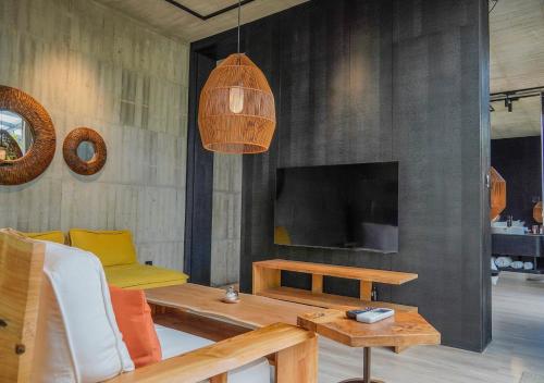 a living room with a couch and a television at Deer Chaser Hotel in Yuchi