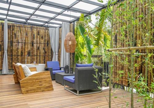 a patio with furniture and plants on a wooden deck at Deer Chaser Hotel in Yuchi