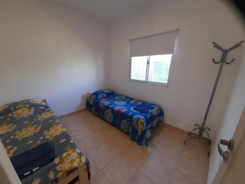 Kleines Zimmer mit einem Bett und einem Fenster in der Unterkunft La Cañada in Juana Koslay 