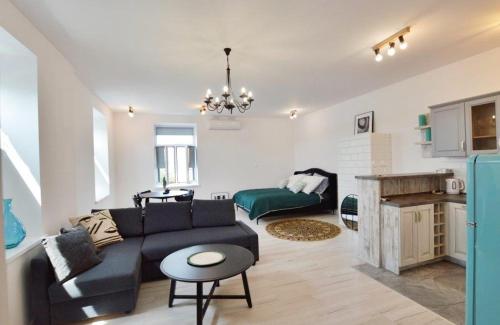 a living room with a couch and a table at Apartament nad Wisłą in Płock